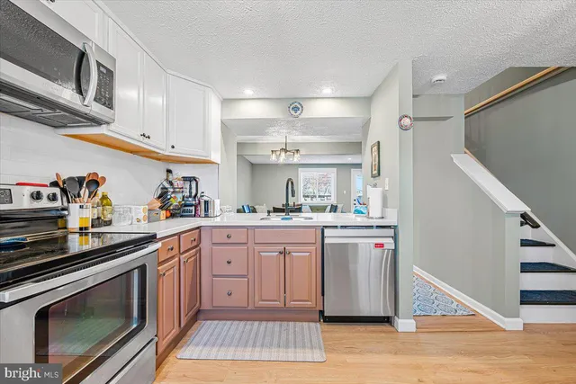 a kitchen with a sink stove and cabinets