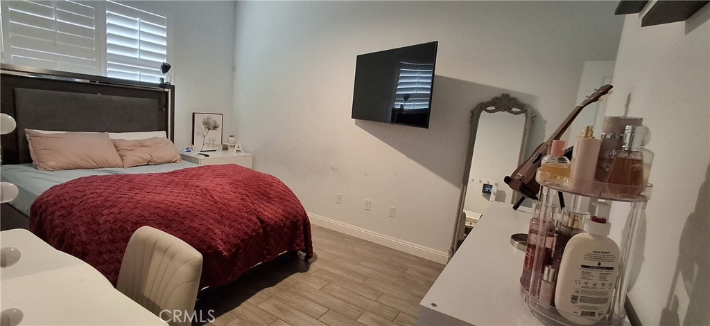 12322 Champlin Place Bakersfield, CA 93311 - Photo 31 of 33 a spacious bedroom with a bed and wooden floor