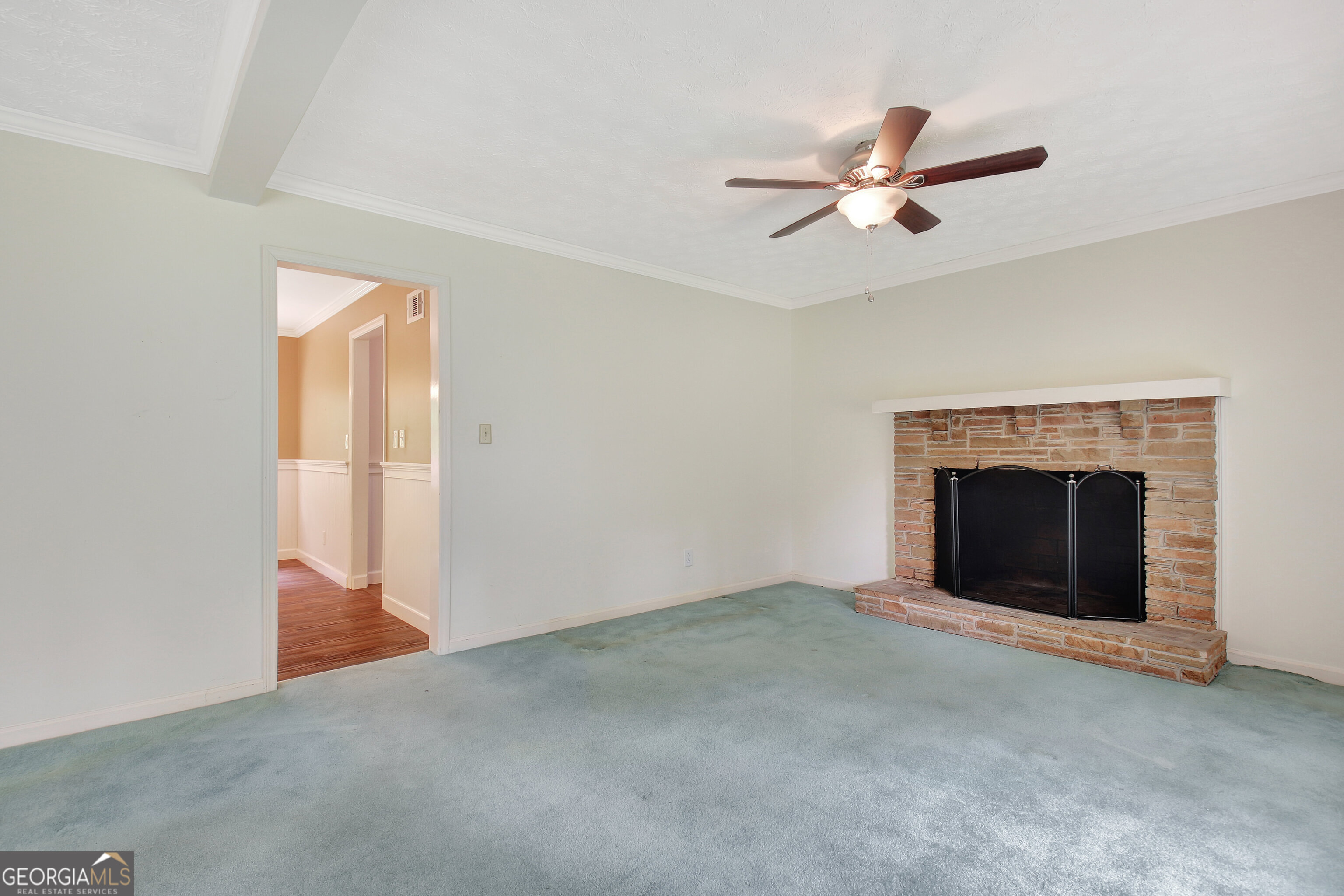 717 Tyrone Road Tyrone, GA 30290 - Photo 14 of 58 a view of an empty room with chandelier fan and fire place