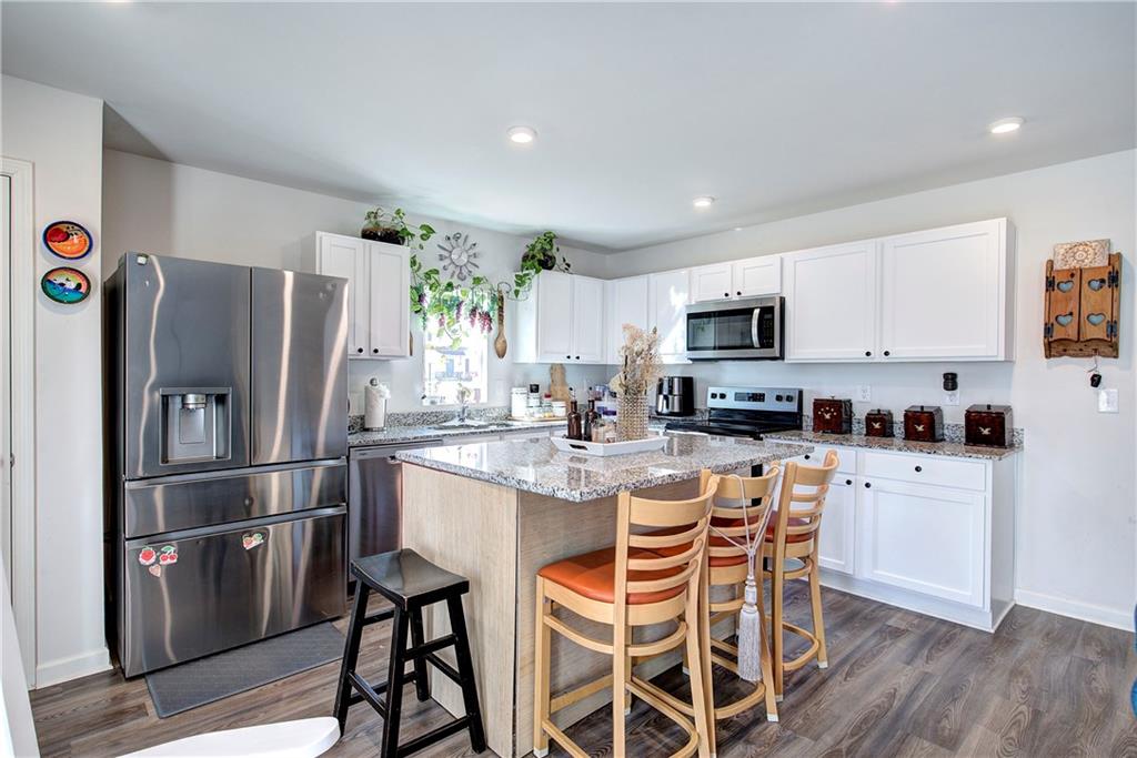 635 Tudor Street Euharlee, GA 30145 - Photo 15 of 39 a kitchen with stainless steel appliances granite countertop a refrigerator and a stove top oven
