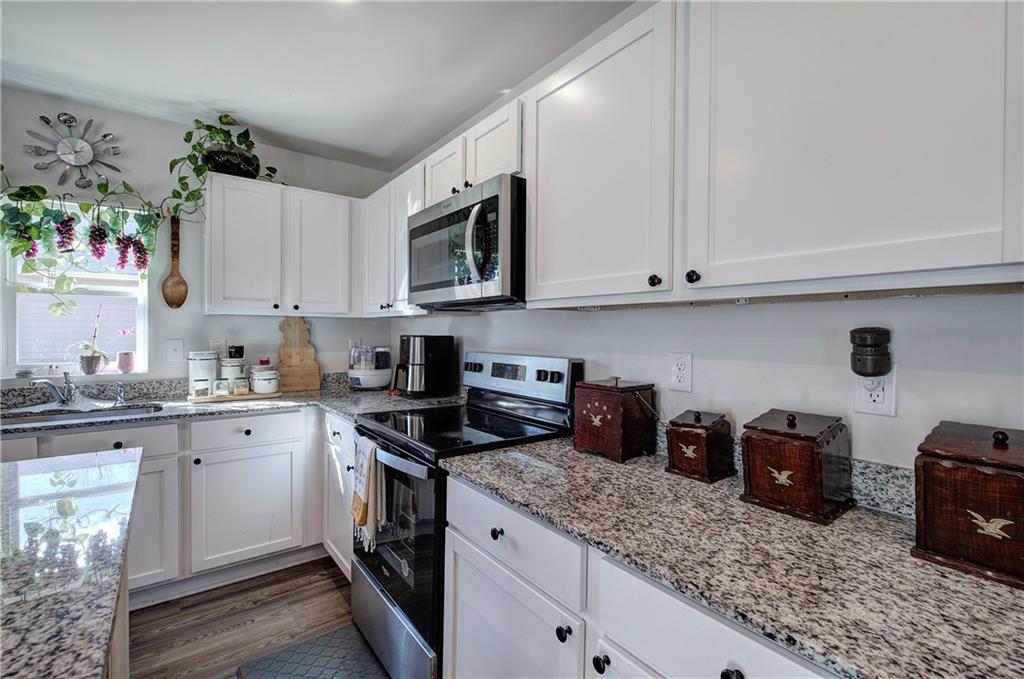 635 Tudor Street Euharlee, GA 30145 - Photo 17 of 39 a kitchen with stainless steel appliances granite countertop a sink and cabinets