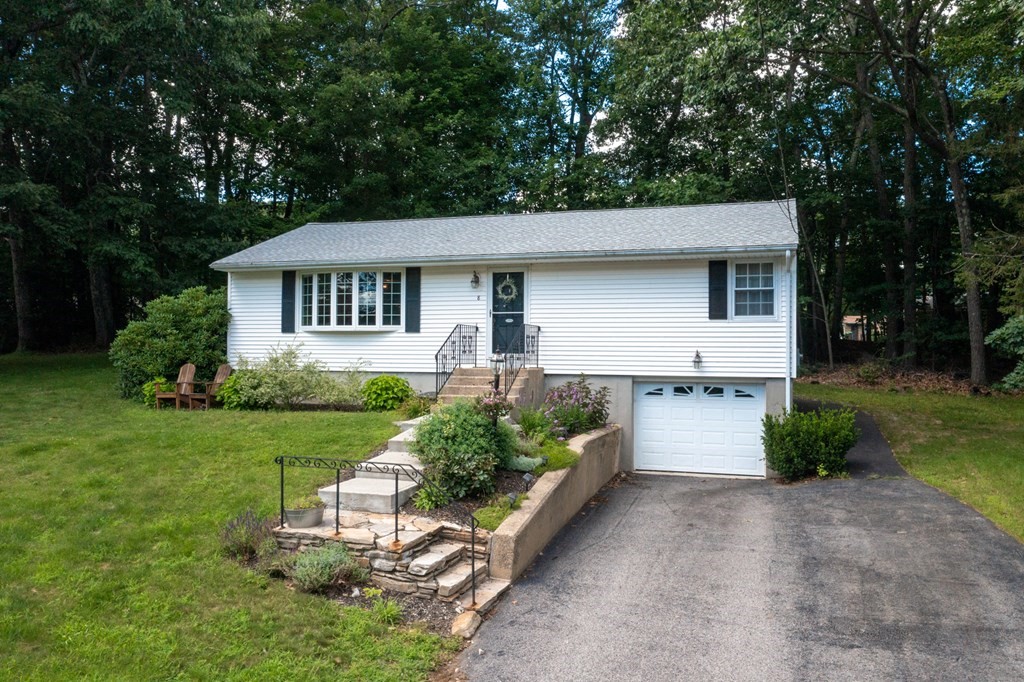 8 Juniper Lane Rutland, MA 01543 - Photo 2 of 36 a front view of a house with a yard and garage