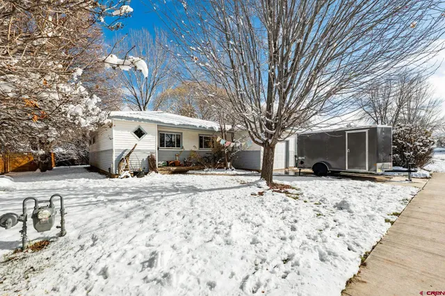 a view of a house with snow on the road