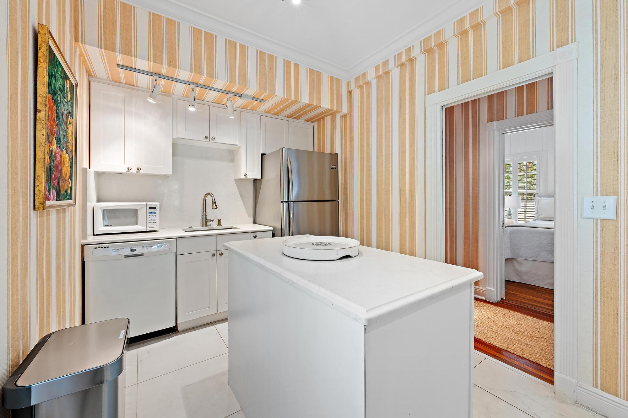 151 South County Road, Unit 1 Palm Beach, FL 33480 - Photo 6 of 18 a kitchen with a sink cabinets and wooden floor