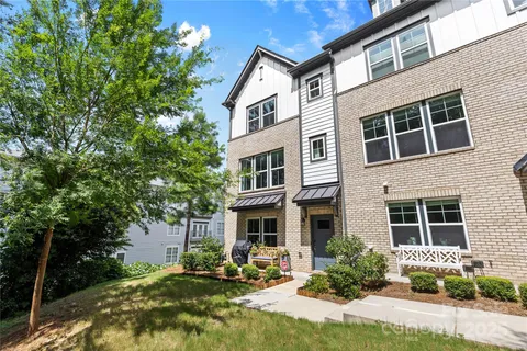 a front view of a residential apartment building with a yard