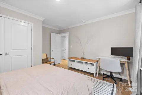 a bedroom with a bed and a desk