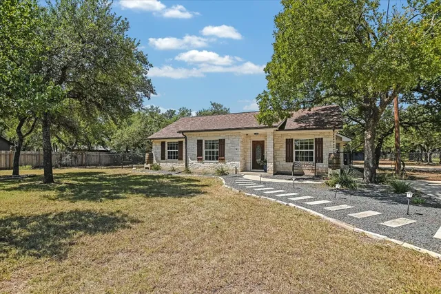 a front view of house with yard and green space