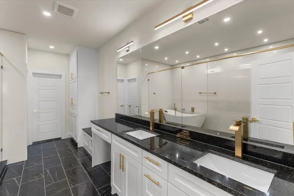 a bathroom with a double vanity sink and a mirror