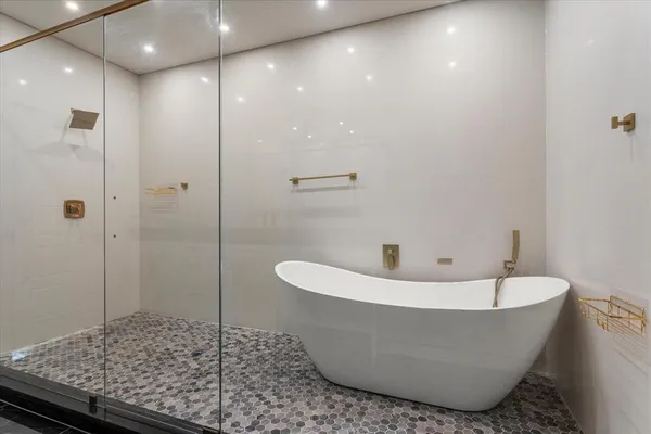 a bathroom with a bathtub and shower