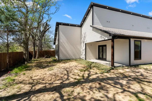 a view of a backyard with a large tree