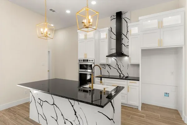 a kitchen with a table chairs and cabinets