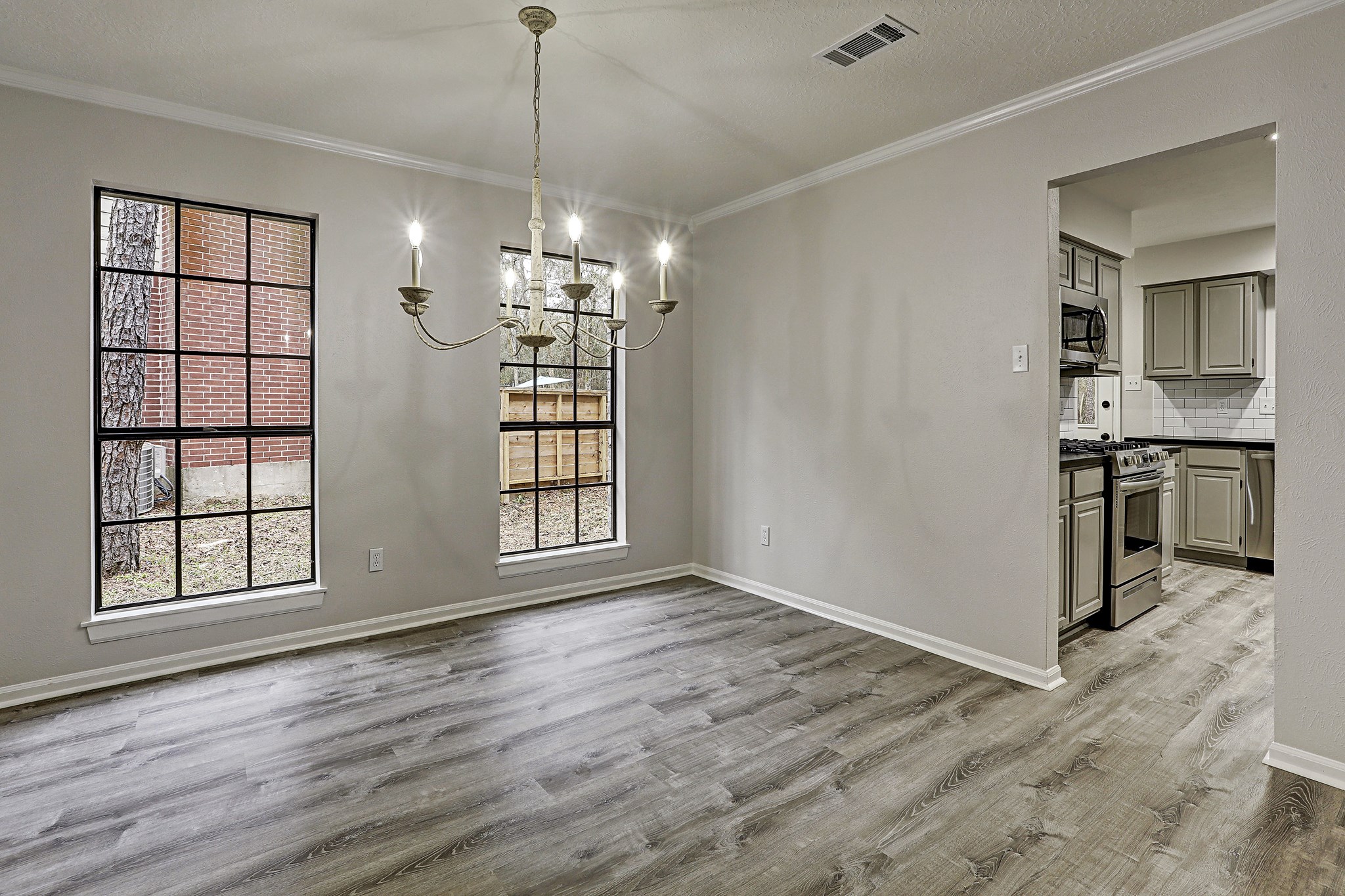 2 Eagle Rock Place Spring, TX 77381 - Photo 4 of 16 The formal dining room features a beautiful chandelier and floor to ceiling windows.