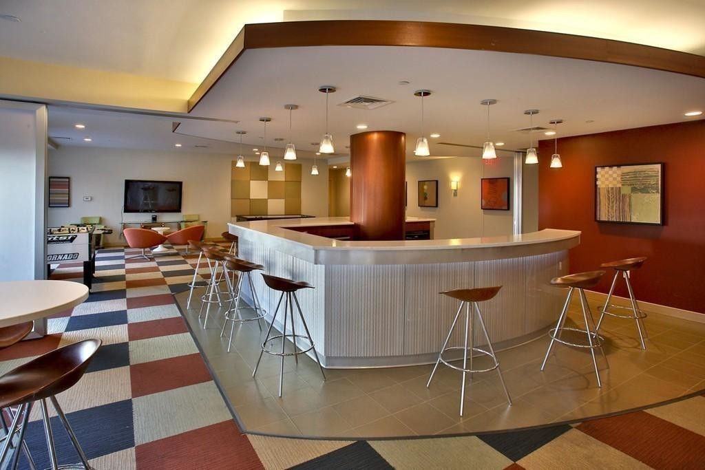 303 Third Street, Unit 417 Cambridge, MA 02142 - Photo 17 of 22 a dining hall with couches a dining table and chairs with a dining table