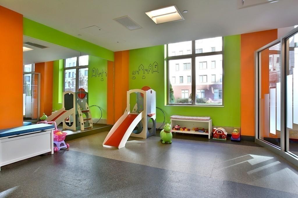 303 Third Street, Unit 417 Cambridge, MA 02142 - Photo 19 of 22 a bedroom with furniture and a window