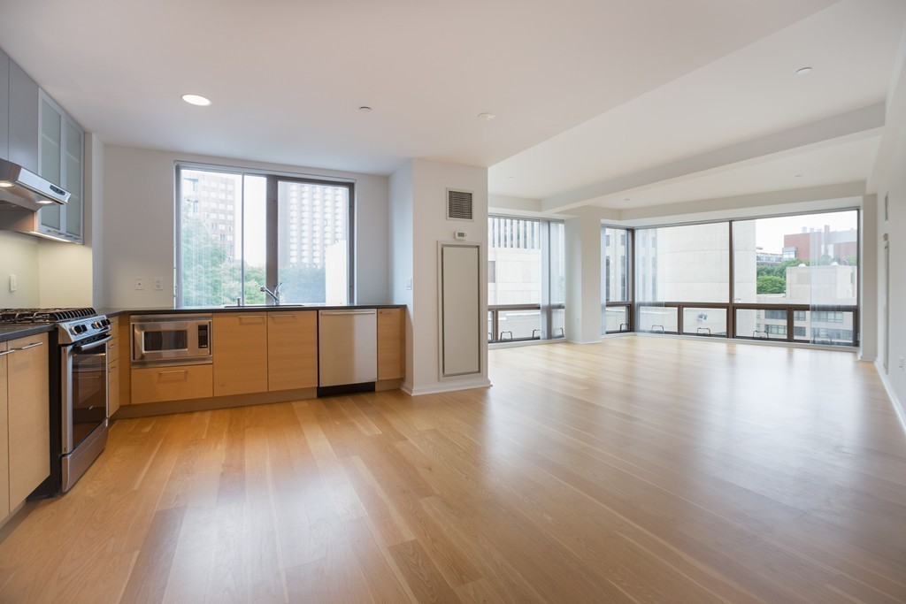 303 Third Street, Unit 417 Cambridge, MA 02142 - Photo 3 of 22 a view of a livingroom with wooden floor and a window