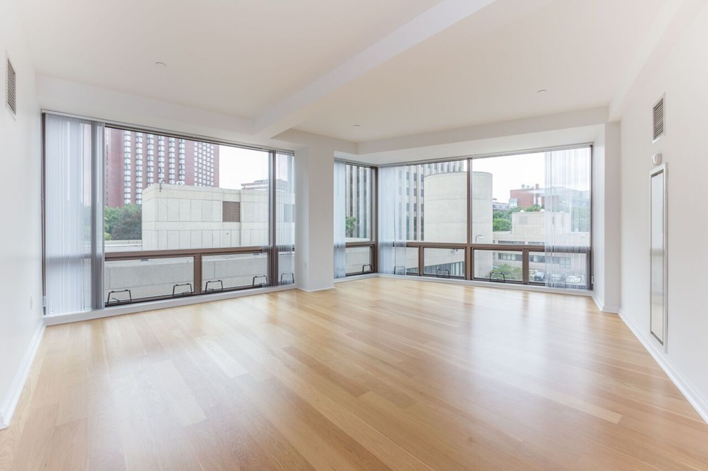 303 Third Street, Unit 417 Cambridge, MA 02142 - Photo 5 of 22 wooden floor in an empty room with a window