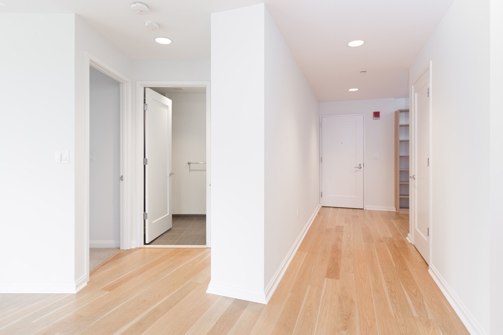 303 Third Street, Unit 417 Cambridge, MA 02142 - Photo 7 of 22 a view of hallway with wooden floor
