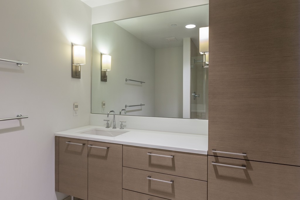 303 Third Street, Unit 417 Cambridge, MA 02142 - Photo 10 of 22 a bathroom with a sink and a mirror