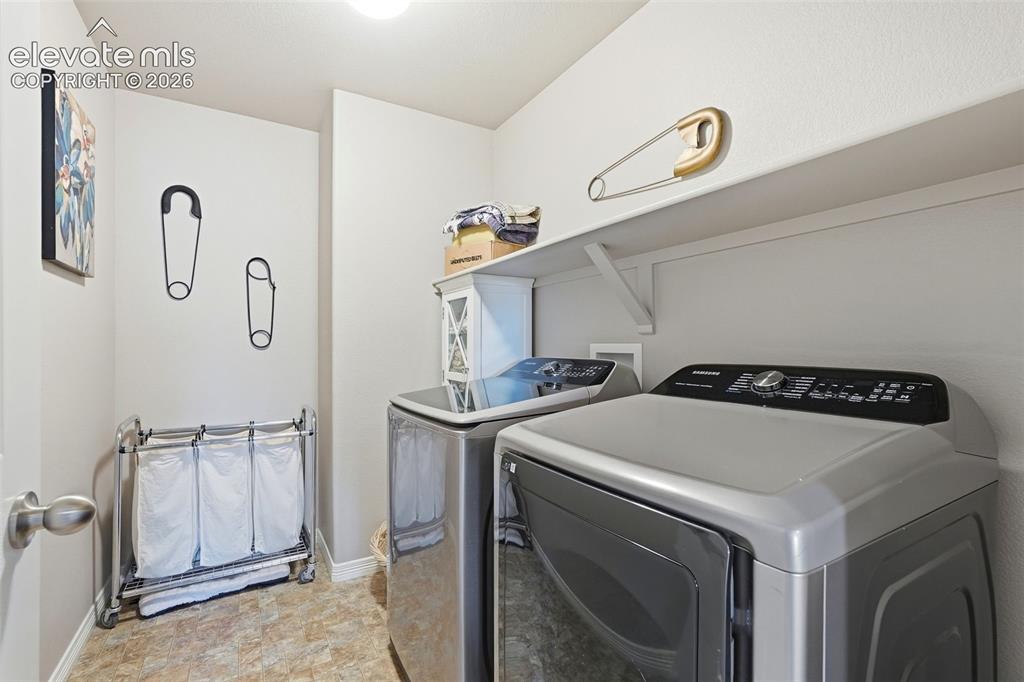 2264 Reed Grass Way Colorado Springs, CO 80915 - Photo 35 of 50 a utility room with dryer and washer