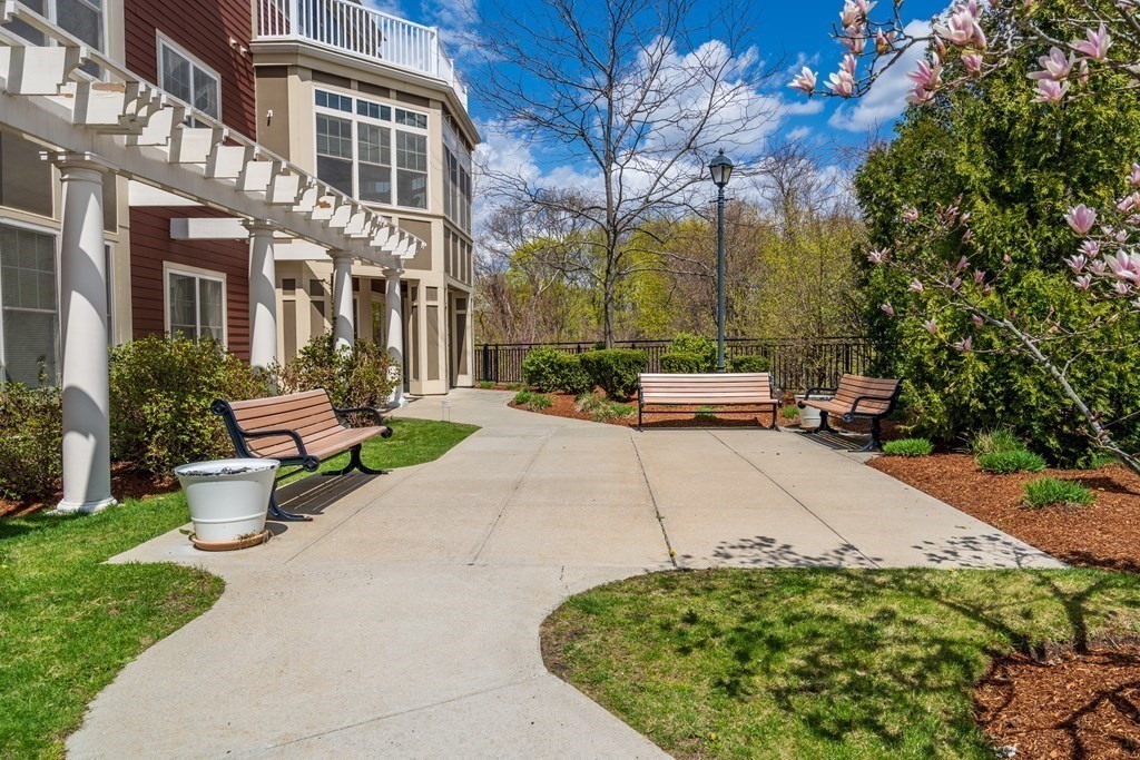 35 Commonwealth Avenue, Unit 103 Newton, MA 02467 - Photo 1 of 23 a view of a building with garden and sitting area