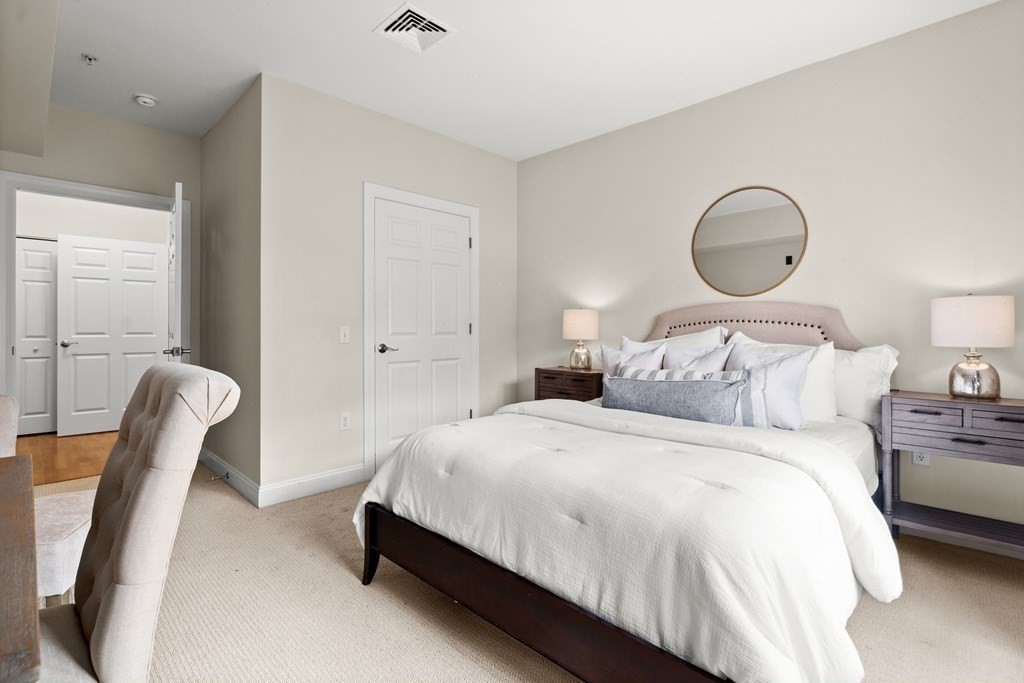 35 Commonwealth Avenue, Unit 103 Newton, MA 02467 - Photo 13 of 23 a bedroom with bed and a chair