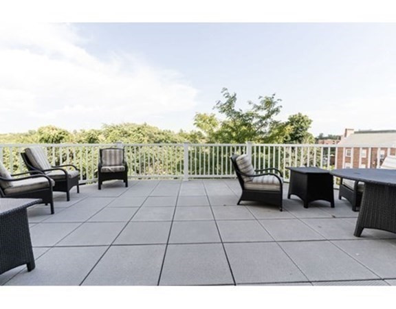 35 Commonwealth Avenue, Unit 103 Newton, MA 02467 - Photo 17 of 23 a view of a terrace with couches and wooden floor