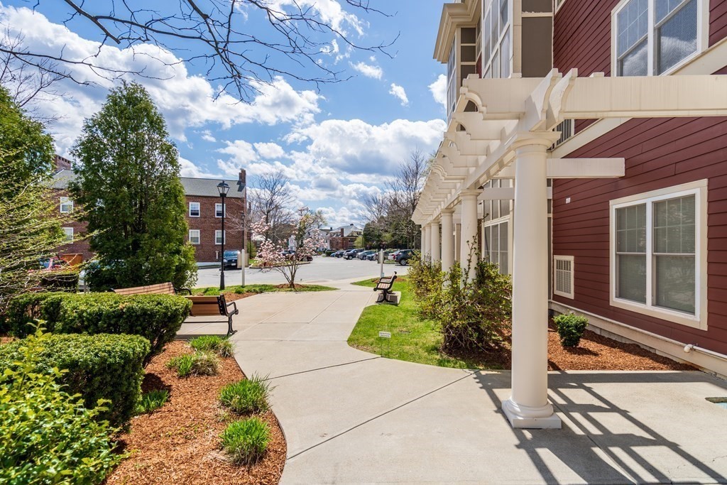 35 Commonwealth Avenue, Unit 103 Newton, MA 02467 - Photo 22 of 23 a view of a building with garden and sitting area