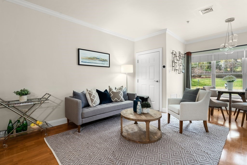35 Commonwealth Avenue, Unit 103 Newton, MA 02467 - Photo 6 of 23 a living room with furniture and a large window