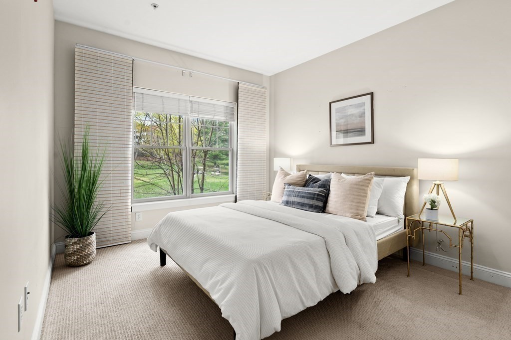 35 Commonwealth Avenue, Unit 103 Newton, MA 02467 - Photo 10 of 23 a bedroom with a bed and a large window