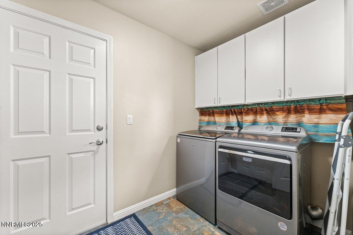 10420 Silver Rush Court Reno, NV 89521 - Photo 26 of 43 a kitchen with granite countertop white cabinets and white appliances