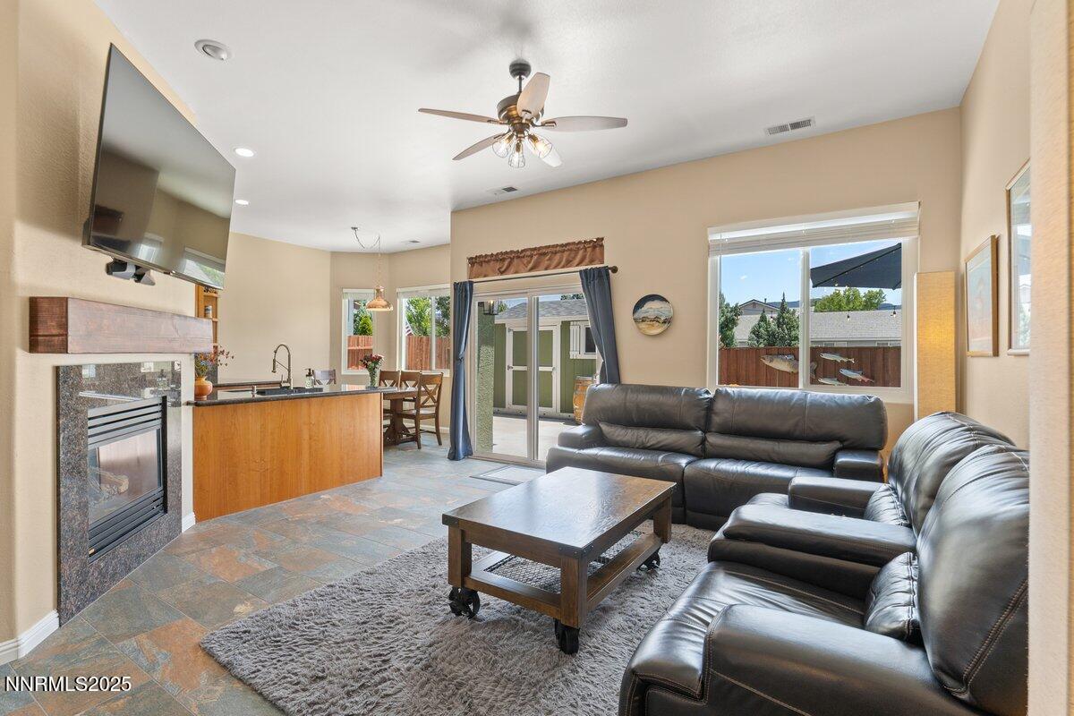 10420 Silver Rush Court Reno, NV 89521 - Photo 8 of 43 a living room with furniture fireplace and a flat screen tv