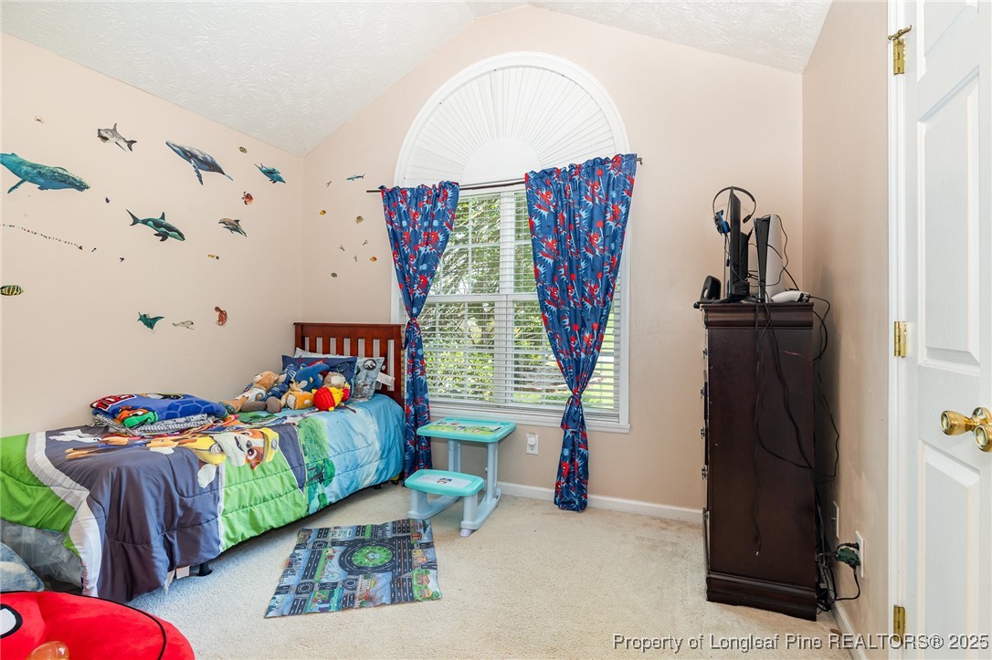 615 Bramblegate Road Hope Mills, NC 28348 - Photo 18 of 26 a bedroom with furniture and a bed
