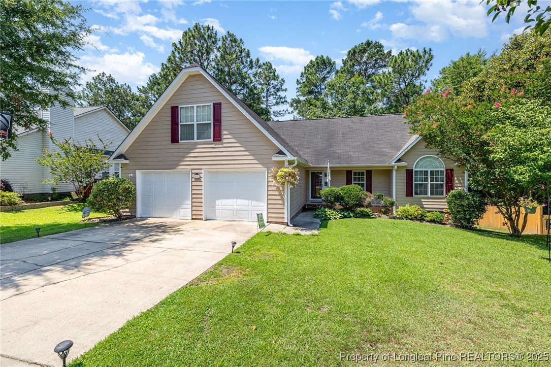 615 Bramblegate Road Hope Mills, NC 28348 - Photo 3 of 26 a front view of a house with a yard and garage