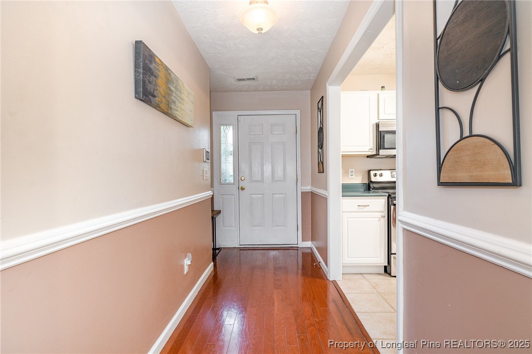 615 Bramblegate Road Hope Mills, NC 28348 - Photo 5 of 26 a view of a hallway with wooden floor and staircase