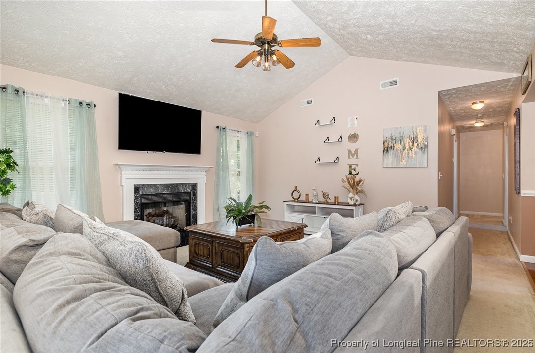 615 Bramblegate Road Hope Mills, NC 28348 - Photo 8 of 26 a living room with furniture fireplace and flat screen tv