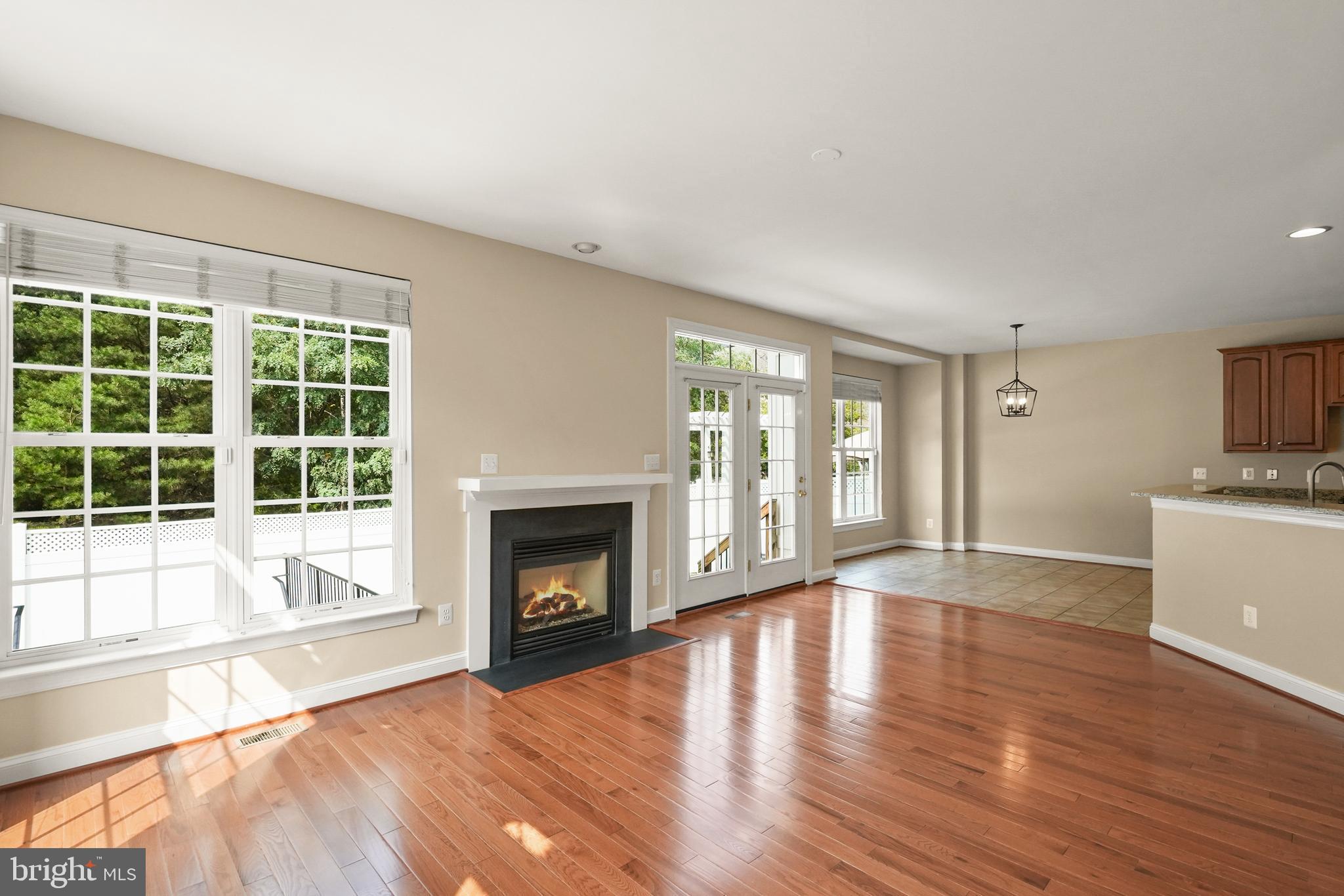 43616 Carradoc Farm Terrace Leesburg, VA 20176 - Photo 12 of 63 a view of an empty room with wooden floor and a window