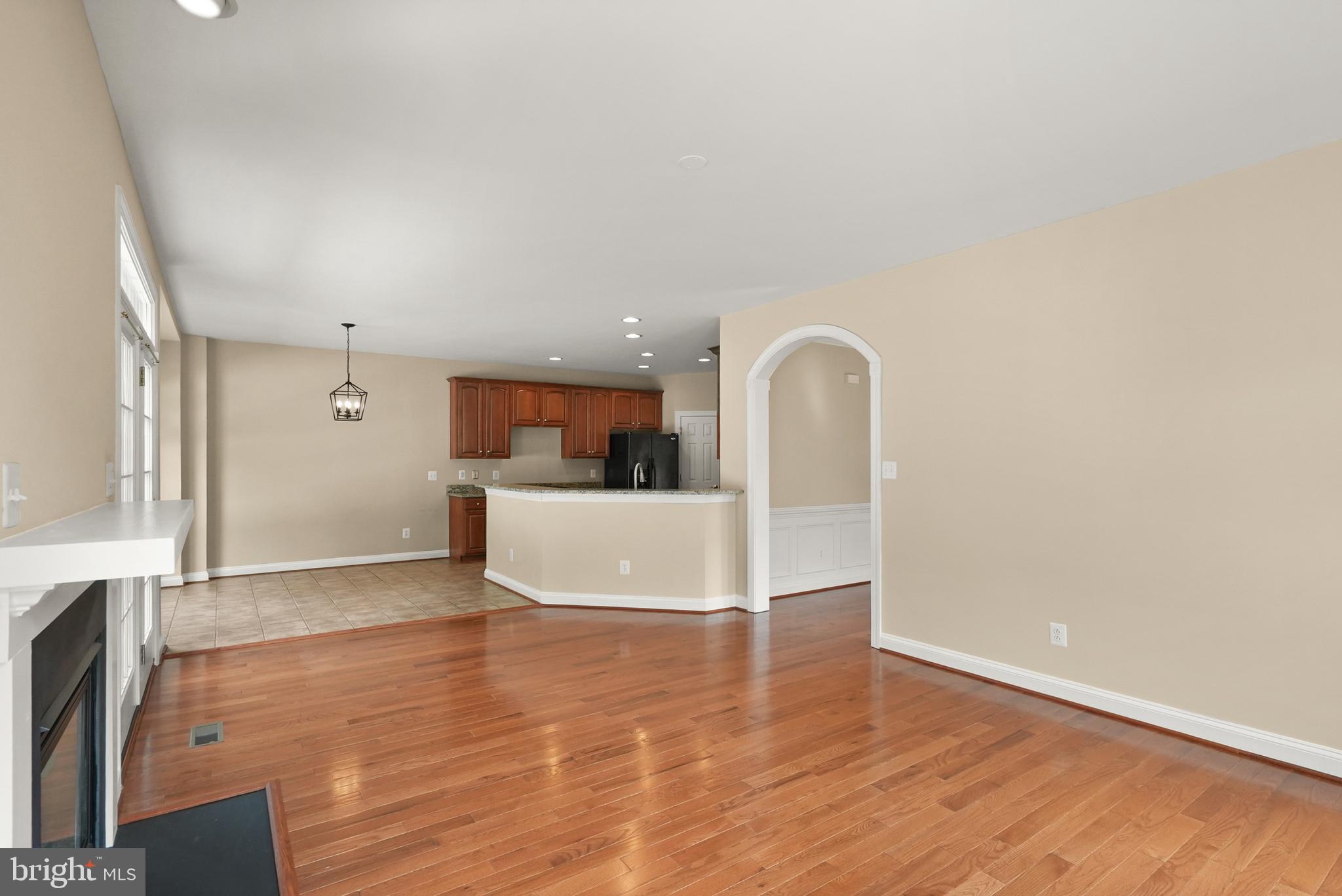 43616 Carradoc Farm Terrace Leesburg, VA 20176 - Photo 13 of 63 a view of a big room with wooden floor and a kitchen