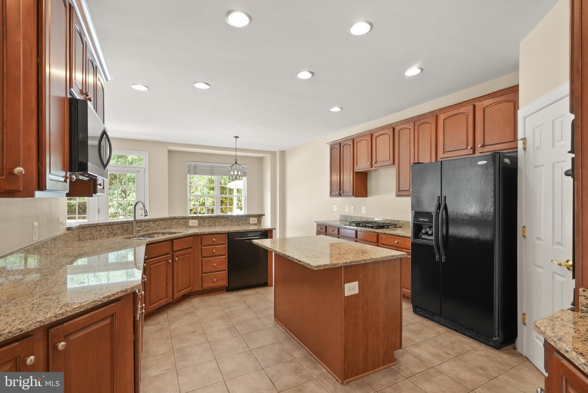 43616 Carradoc Farm Terrace Leesburg, VA 20176 - Photo 16 of 63 a large kitchen with stainless steel appliances granite countertop a sink counter space and a large window