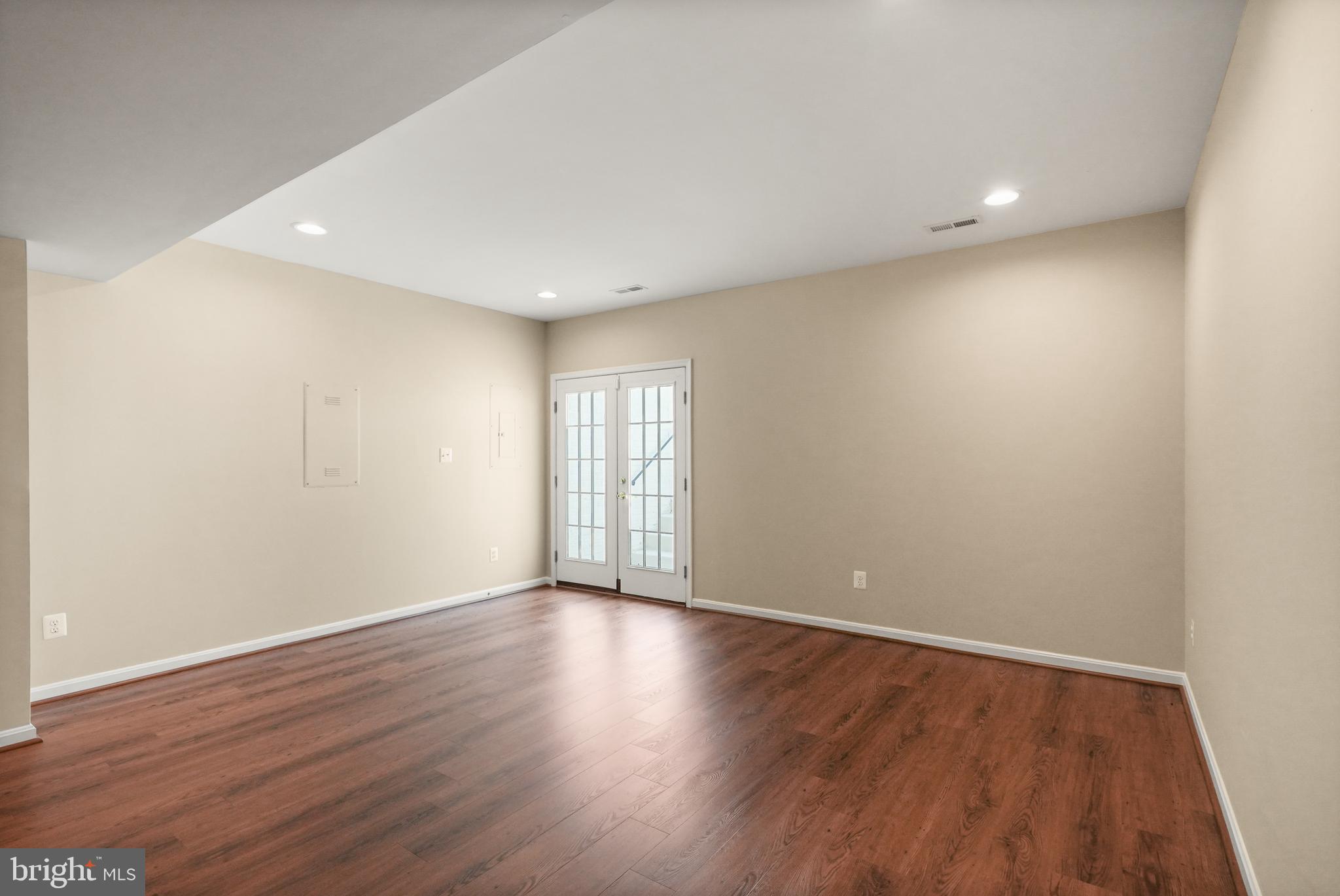 43616 Carradoc Farm Terrace Leesburg, VA 20176 - Photo 45 of 63 a view of an empty room with wooden floor and a window