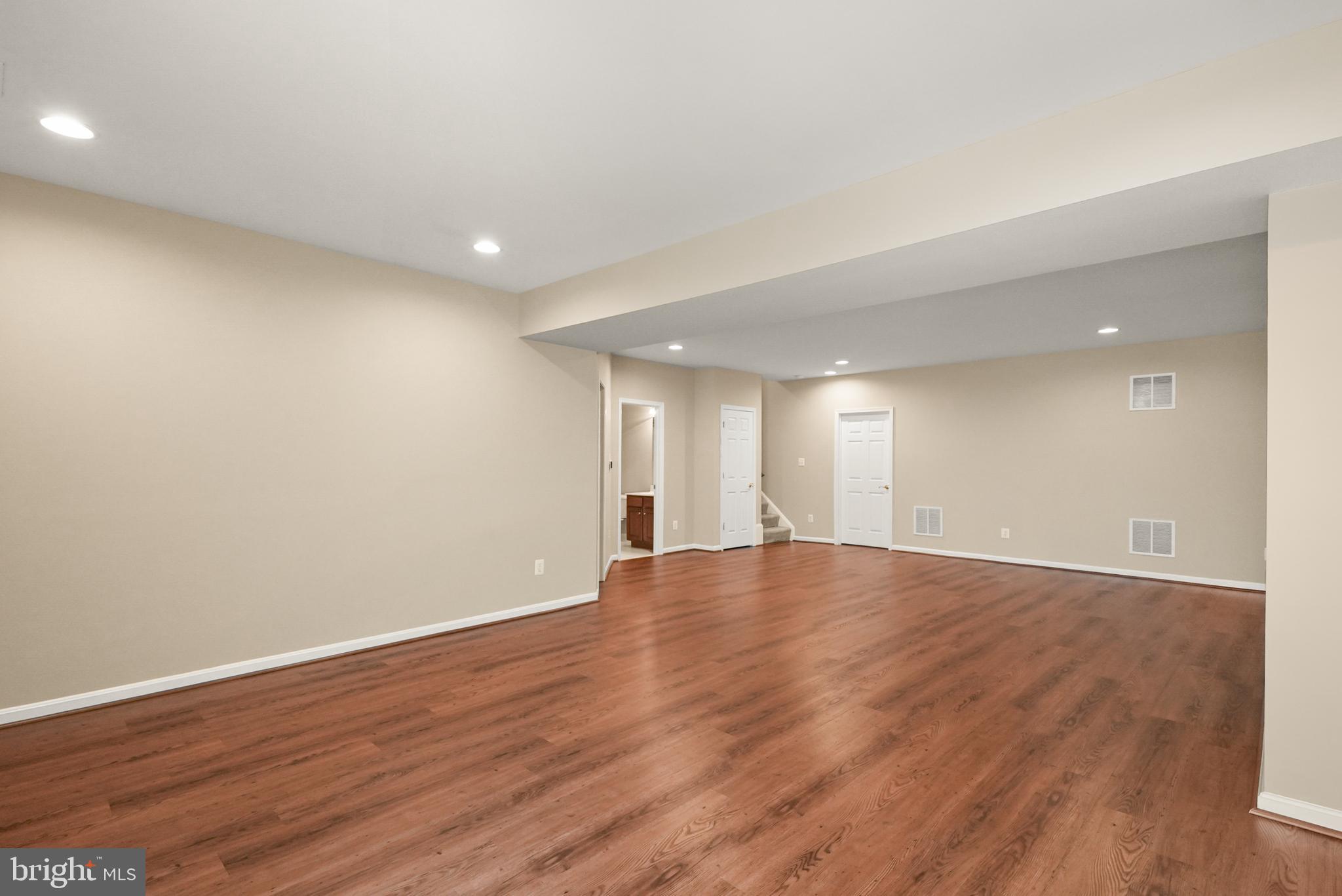 43616 Carradoc Farm Terrace Leesburg, VA 20176 - Photo 47 of 63 a view of an empty room with wooden floor and entryway