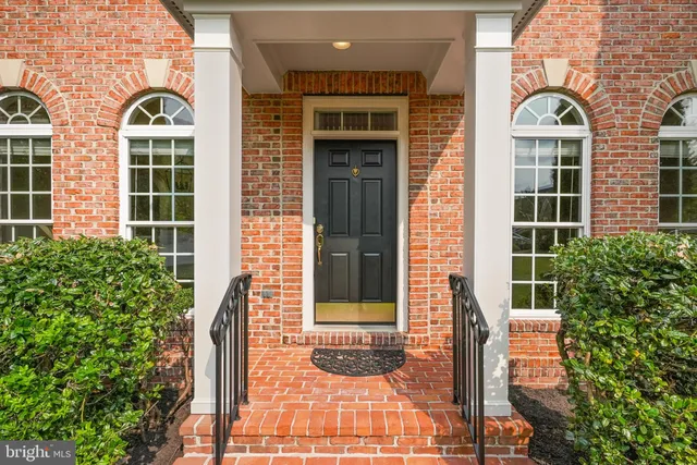 front view of a brick house with a large window