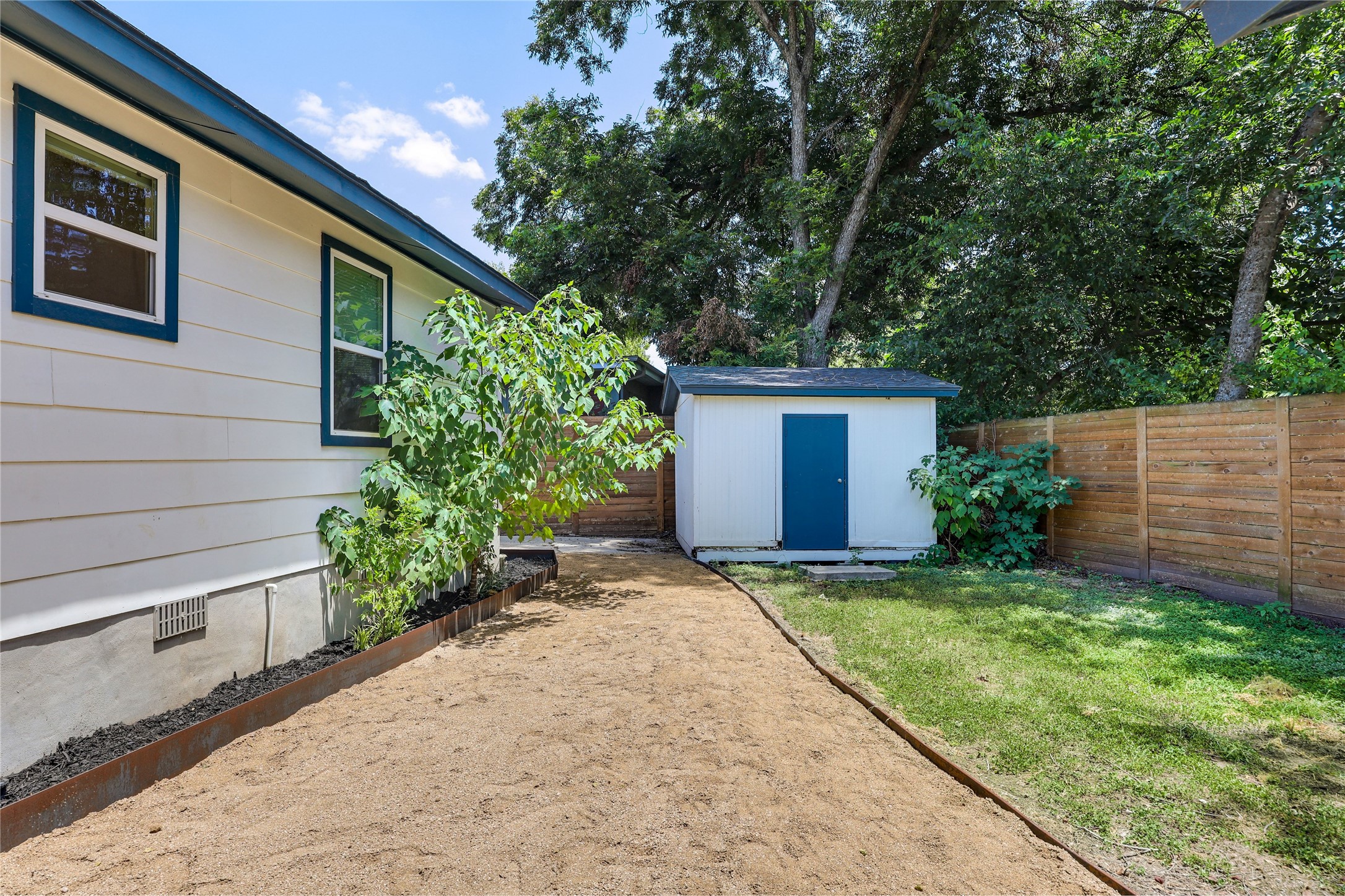 5203 Ledesma Road Austin, TX 78721 - Photo 32 of 40 A private backyard oasis with a convenient shed and newly prepared landscape.