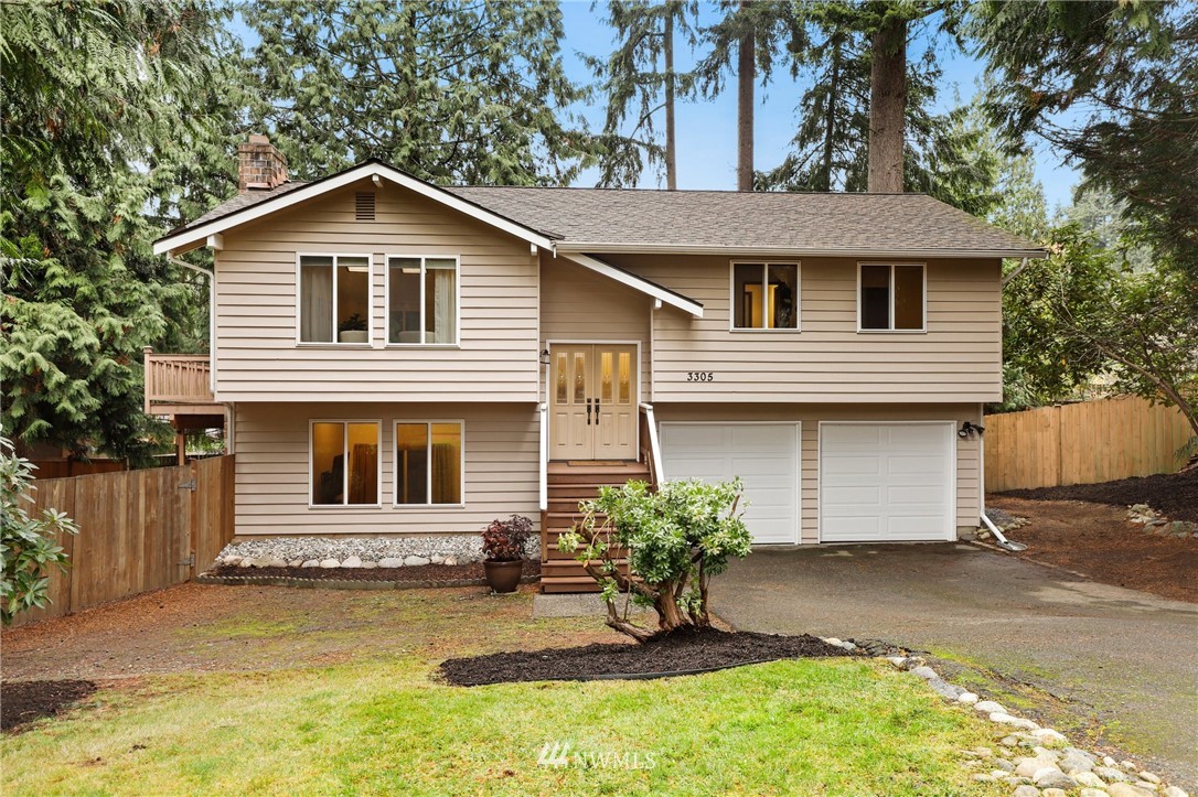 3305 199th Place Southeast Bothell, WA 98012 - Photo 1 of 39 a front view of a house with a yard and garage
