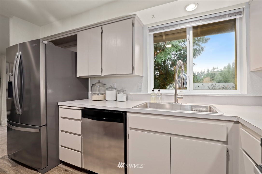 3305 199th Place Southeast Bothell, WA 98012 - Photo 11 of 39 a kitchen with a sink cabinets stainless steel appliances and a window
