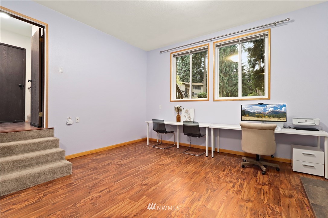 3305 199th Place Southeast Bothell, WA 98012 - Photo 23 of 39 a view of a workspace with wooden floor and a window