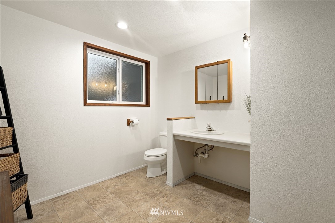 3305 199th Place Southeast Bothell, WA 98012 - Photo 25 of 39 a bathroom with a sink mirror and toilet