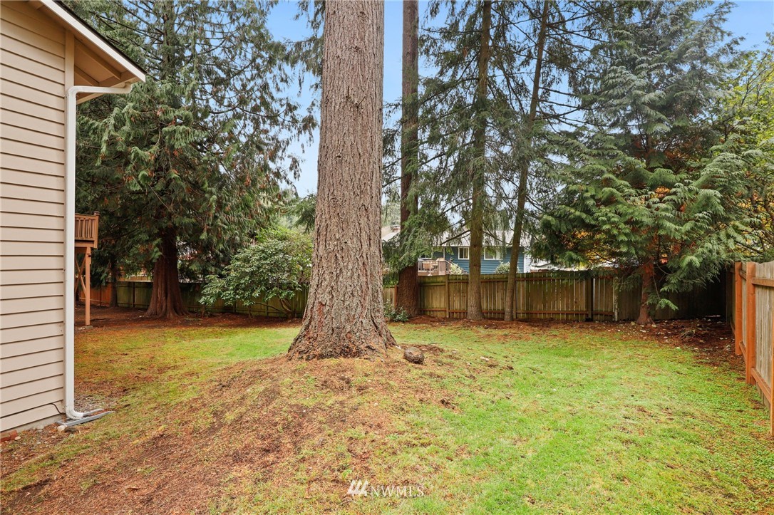 3305 199th Place Southeast Bothell, WA 98012 - Photo 35 of 39 a yellow house with a trees in front of it