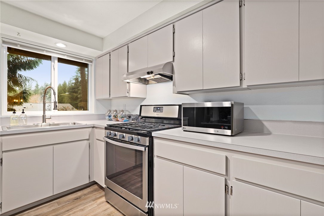 3305 199th Place Southeast Bothell, WA 98012 - Photo 10 of 39 a kitchen with a stove and a sink