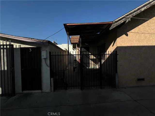 a black car parked in front of a house