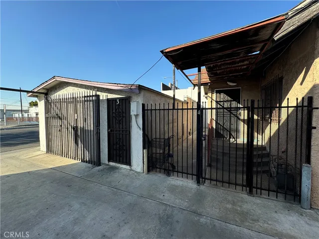 a view of a house with wooden fence